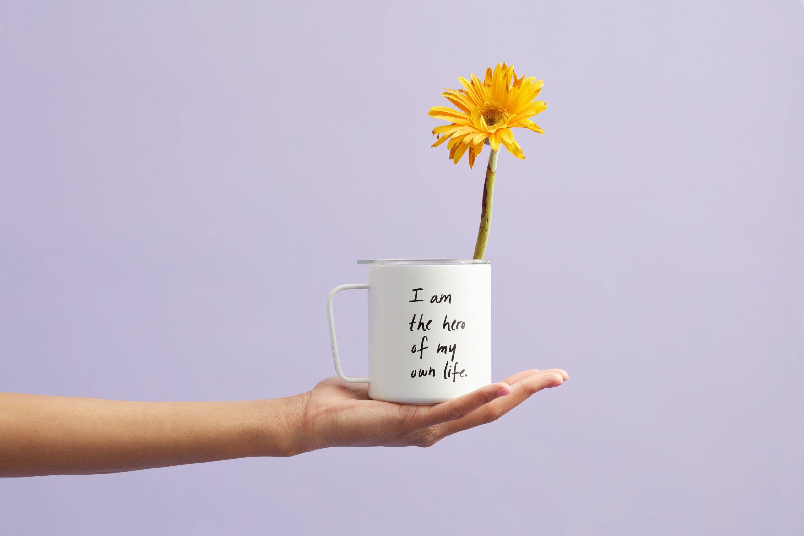 affirmation on a cup with a flower 